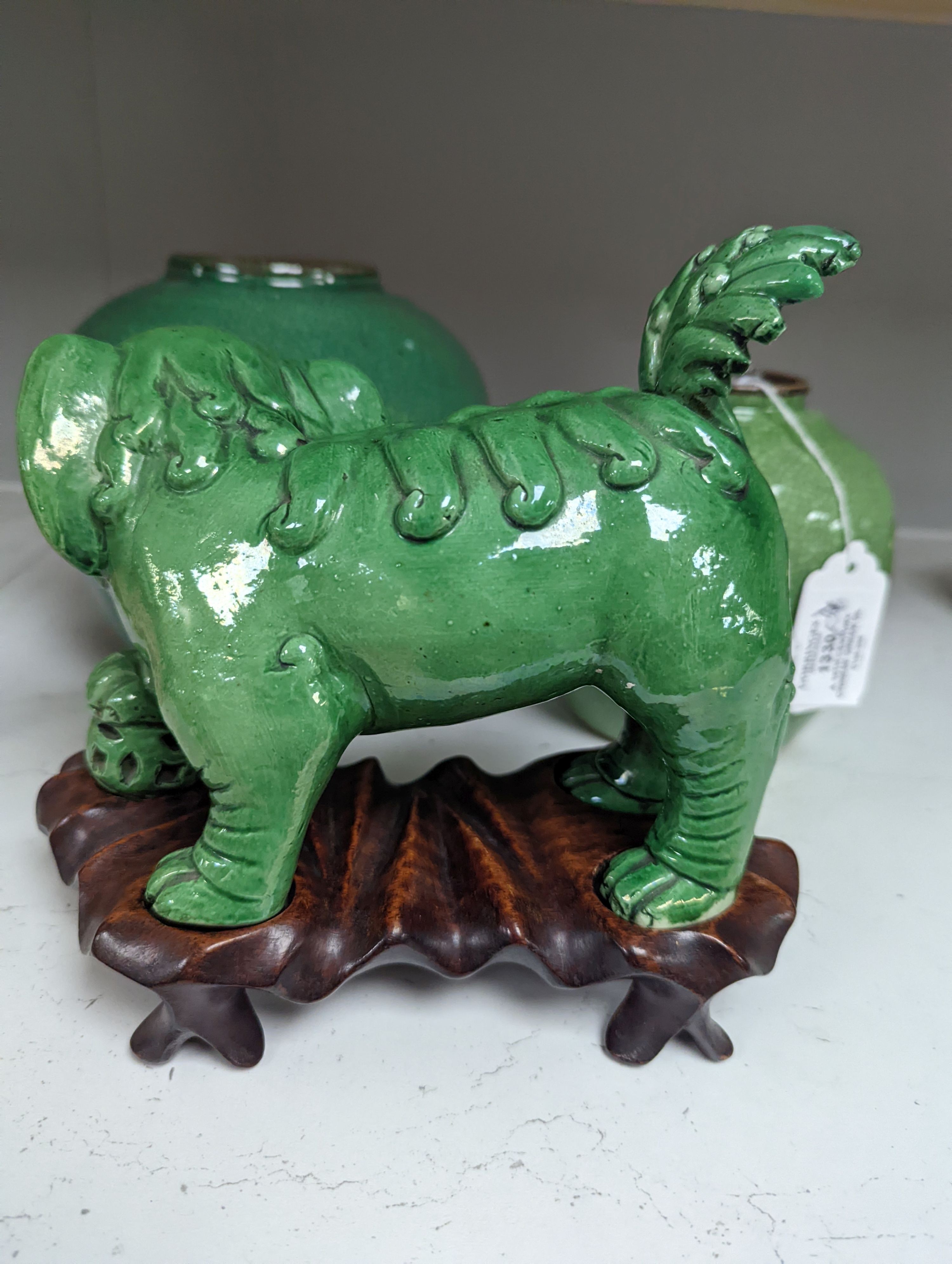 A 19th century Chinese green glazed model of a lion-dog, and two green crackle glaze jars, tallest 16cm